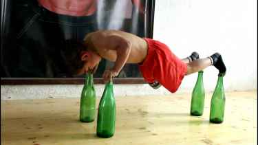 Watch this 5-year-old kid as he does push-up on top of glass bottles