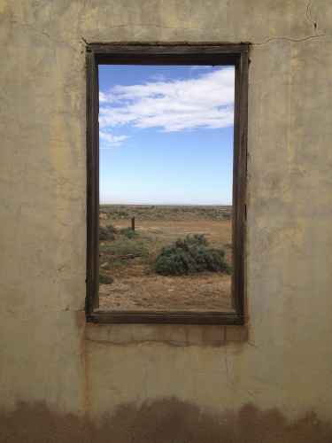 Looking through a window in Australian Outback ruin looks like a picture on a wall