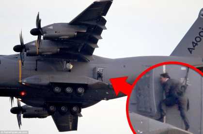 Mission: Impossible's Tom Cruise hangs horizontal outside moving plane